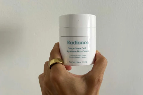 's hand holding radiance cream redaktor's hand holding radiance cream